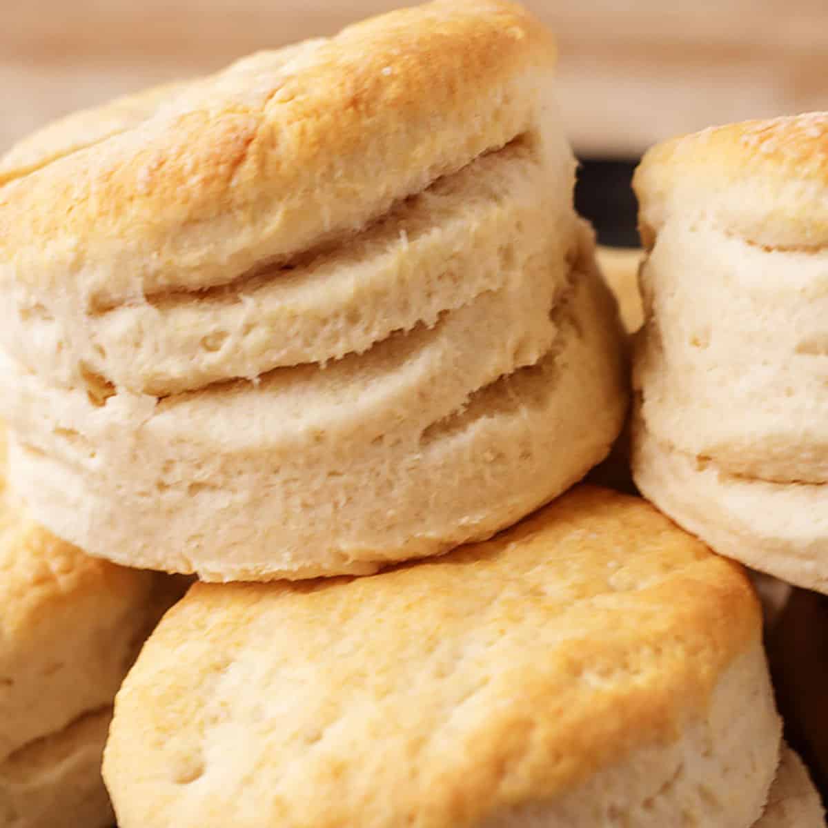 Large stack of homemade biscuits on cast iron.