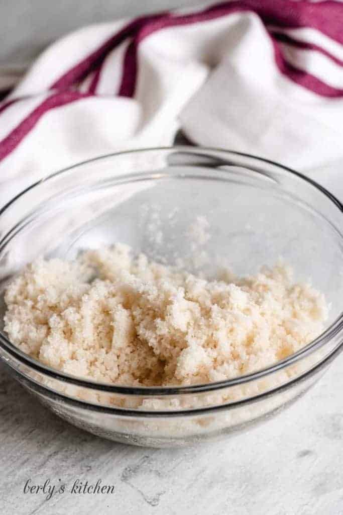 Maple syrup mixed with granulated sugar in a bowl.