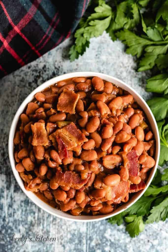 Top-down photo of the finished beans topped with bacon.