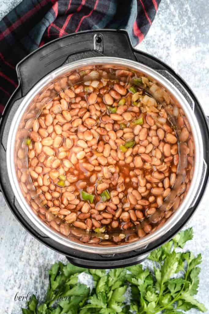 The cooked beans have been added to the peppers and onions.