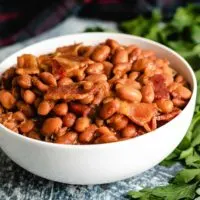 A white bowl filled with Instant Pot baked beans.