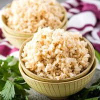 Instant pot brown rice in a yellow bowl.