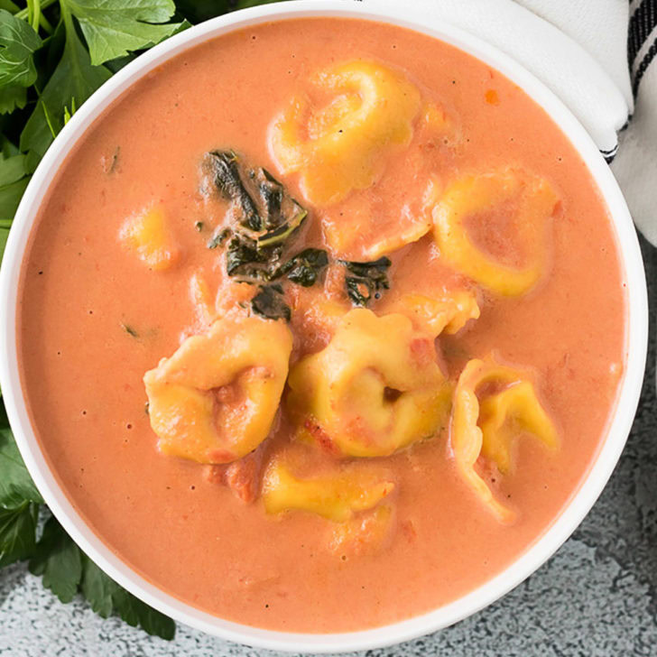 Top down view of a bowl of Instant Pot tortellini soup.