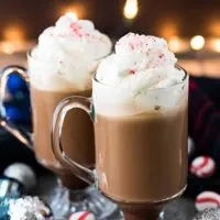 Two glasses of peppermint mocha coffee topped with homemade whipped cream.