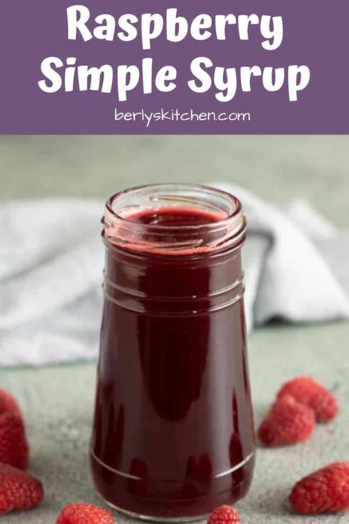 The finished raspberry syrup in a small jam jar.