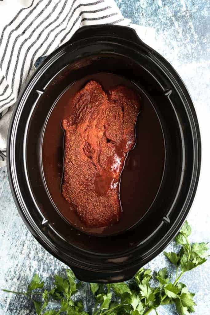 The beef and BBQ sauce have been added to the cooker.