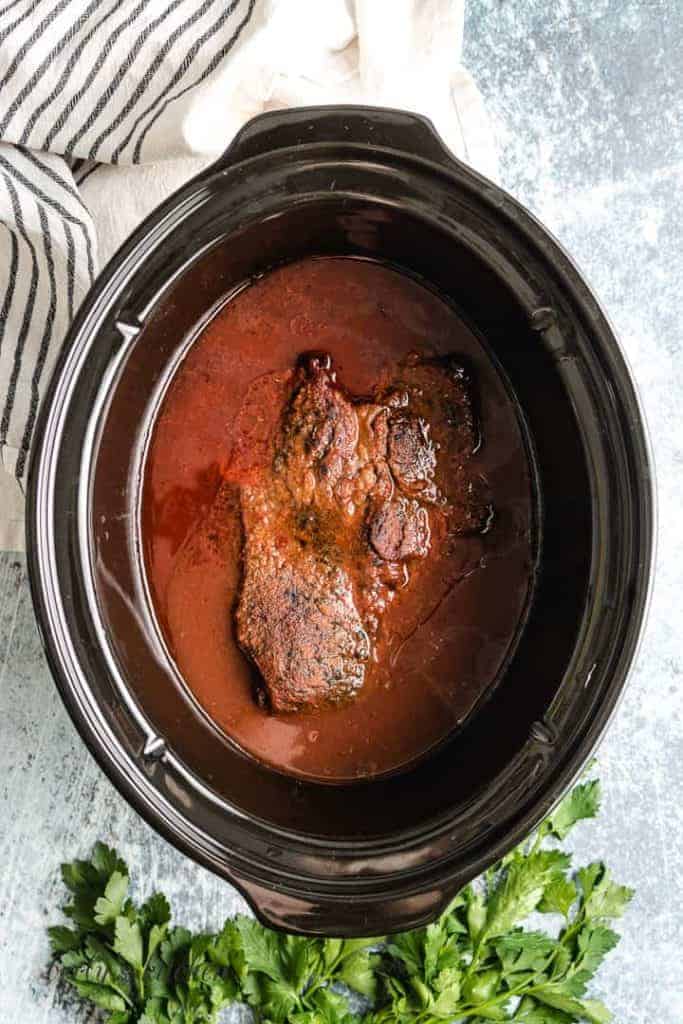 The BBQ beef has cooked and is ready to shred.