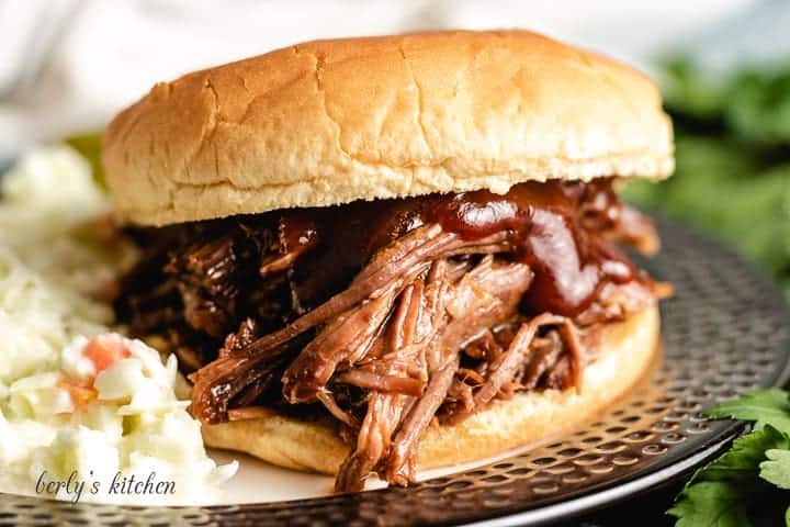 The slow cooker bbq beef shredded and served on a bun.