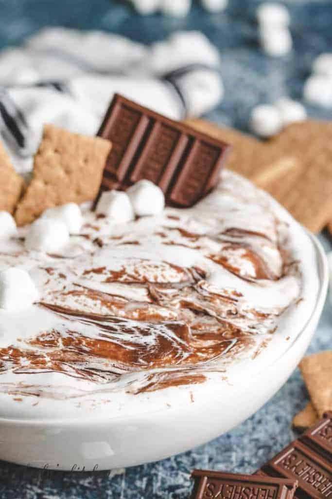 A closer view of the smores dip showing the swirls of fudge and marshmallow.