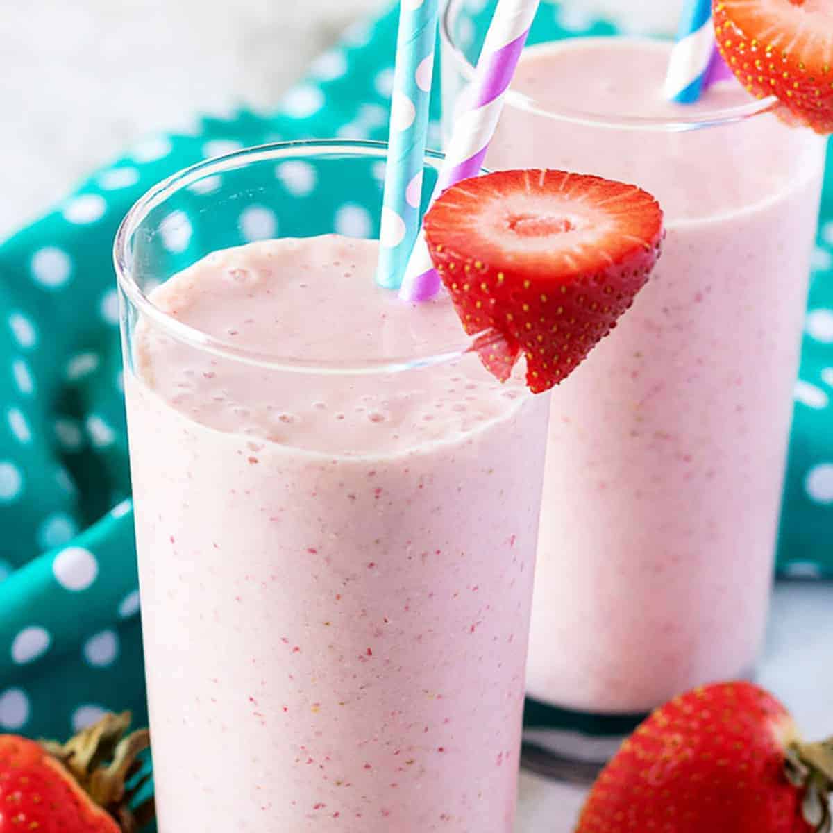 Strawberry banana smoothies in two tall glasses.