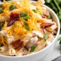 A close-up view of the salad topped with bacon and cheese.