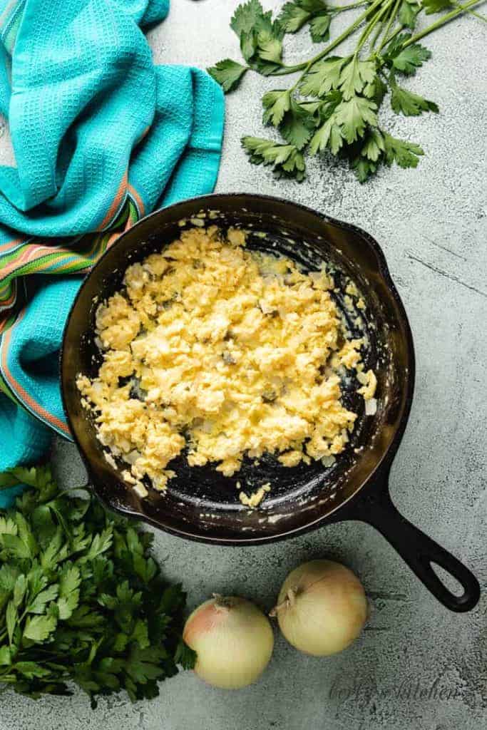 Scrambled eggs cooking in the skillet.