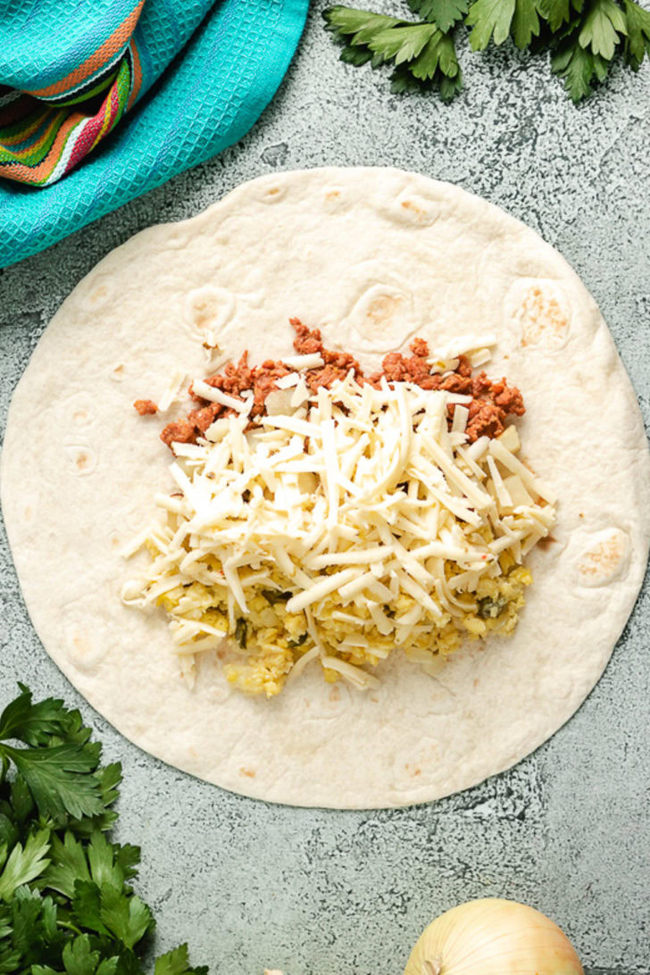 Portions of each ingredient added to a flour tortilla.