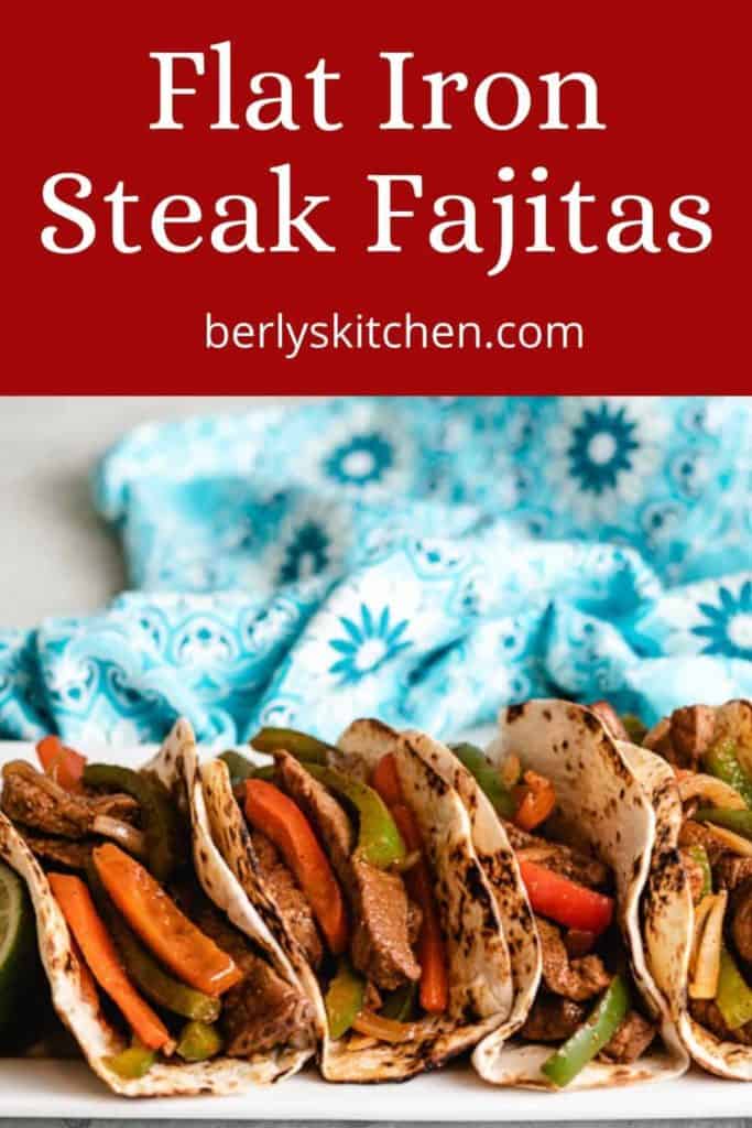 Flat iron steak fajitas served on a rectangular platter.
