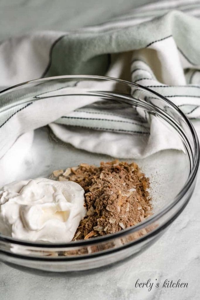 Sour cream and dry soup mix in a bowl.