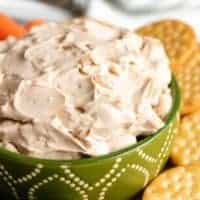 A close-up view of the creamy french onion dip in a serving bowl.