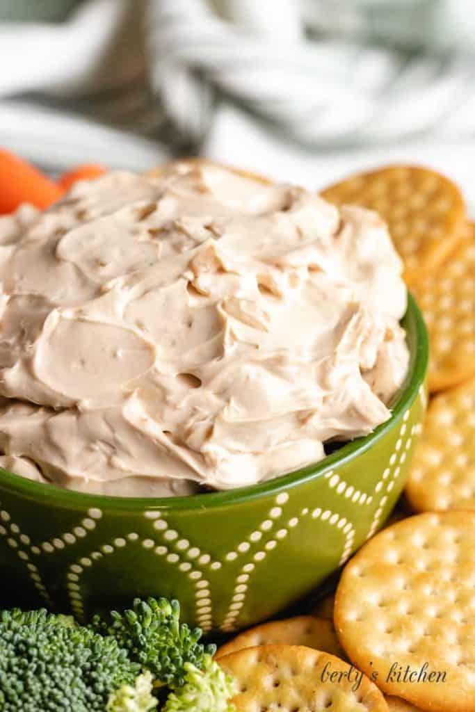 A close-up view of the creamy French onion dip in a serving bowl.