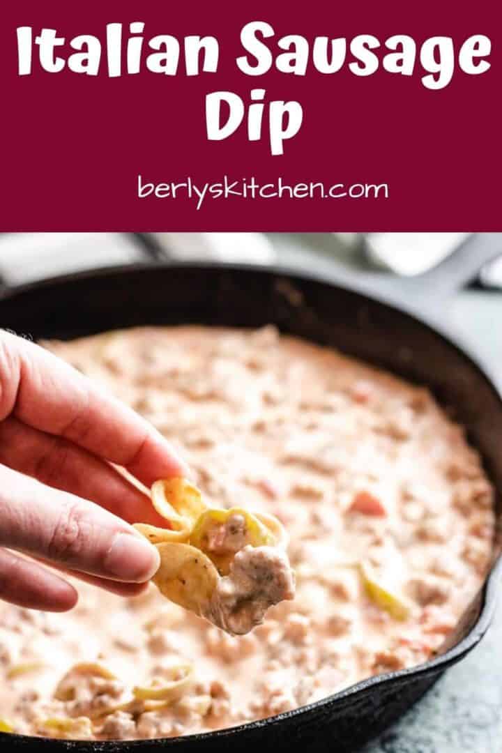 Italian sausage dip being dipped from the pan.