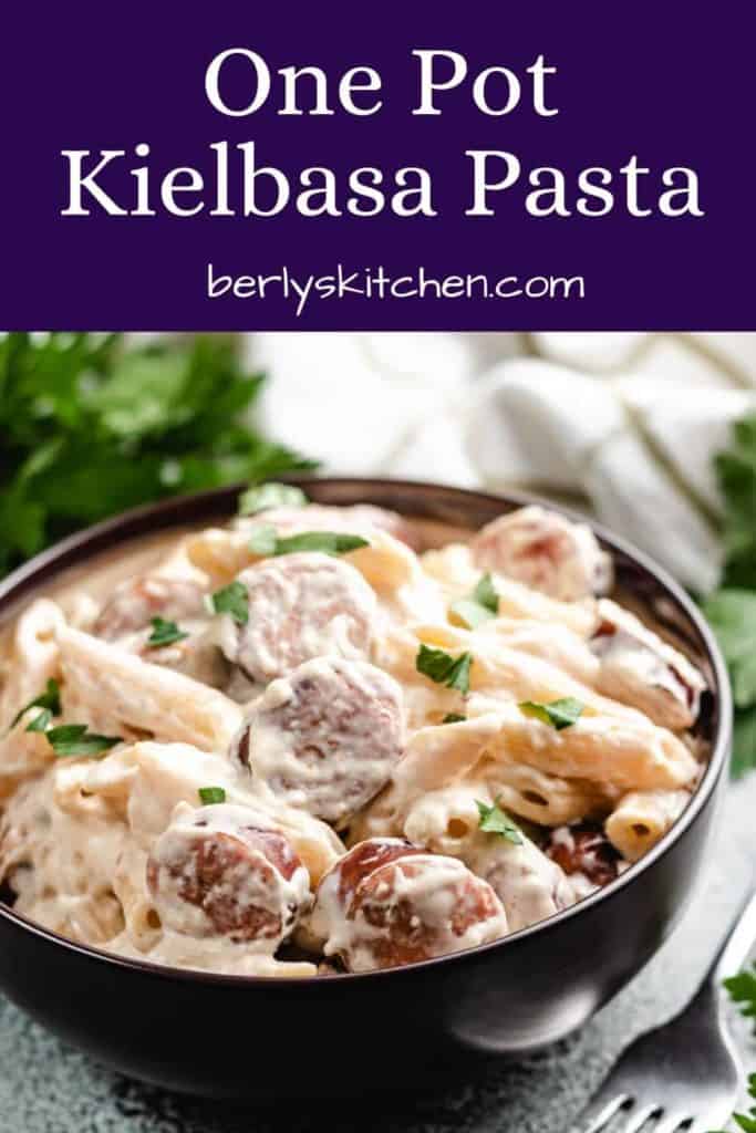 The finished kielbasa pasta served in a brown bowl.