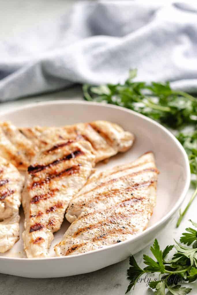 Grilled chicken in large bowl.