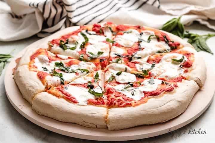 The finished easy Margherita pizza on a pizza stone.