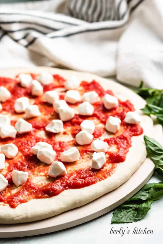 Fresh pearls of mozzarella have been added to the pie.