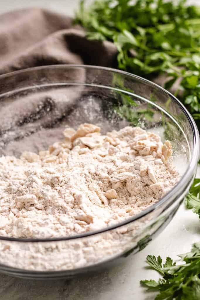 Crushed saltine crackers and spices in a mixing bowl.