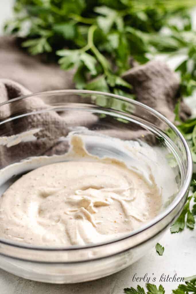 Mayo and spices combined in a mixing bowl.