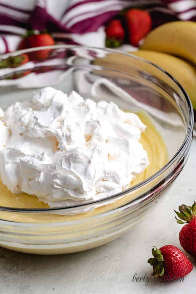 Whipped topping being added to the pudding mix.