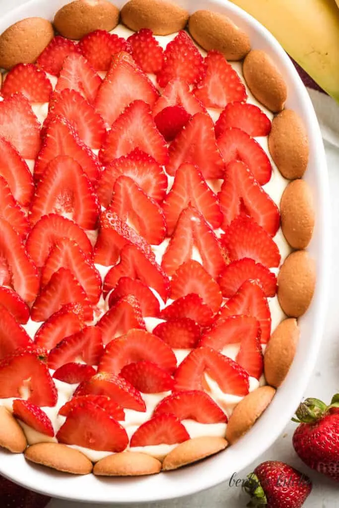 Sliced fresh strawberries on top of the pudding.