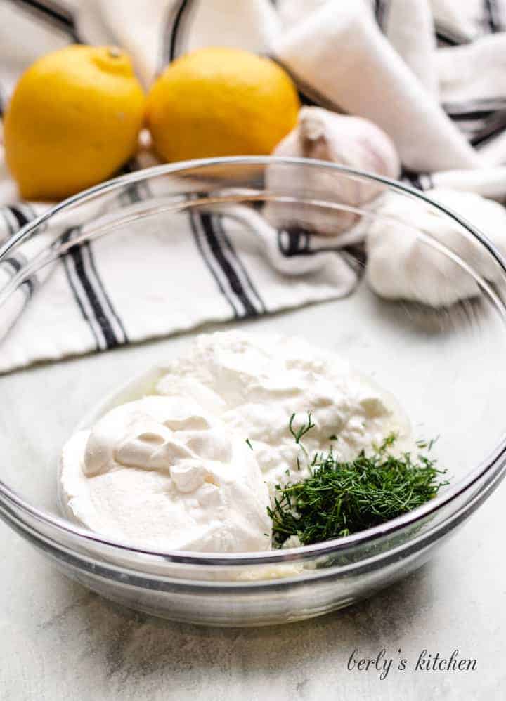Yogurt, sour cream, and other ingredients in a mixing bowl.