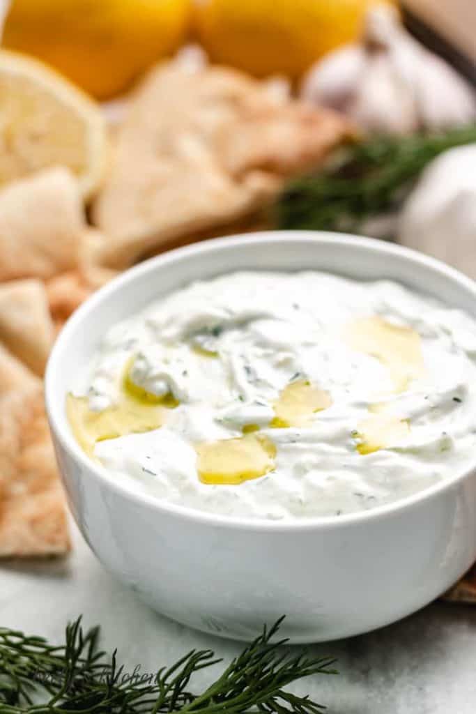 The tzatziki sauce served in a small bowl with chips.