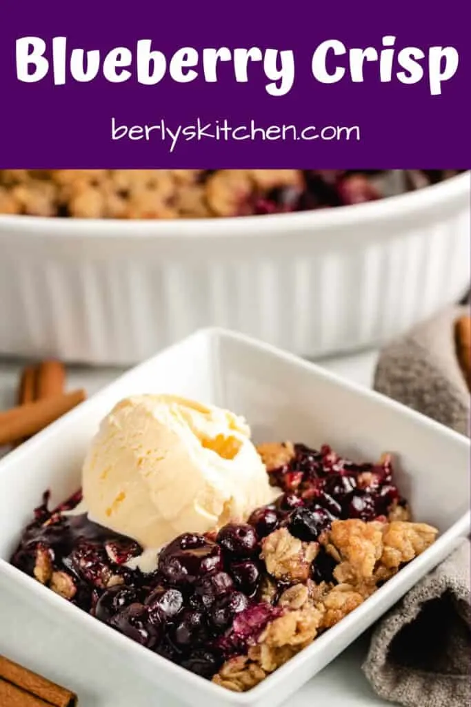 Blueberry crisp served in a square bowl.