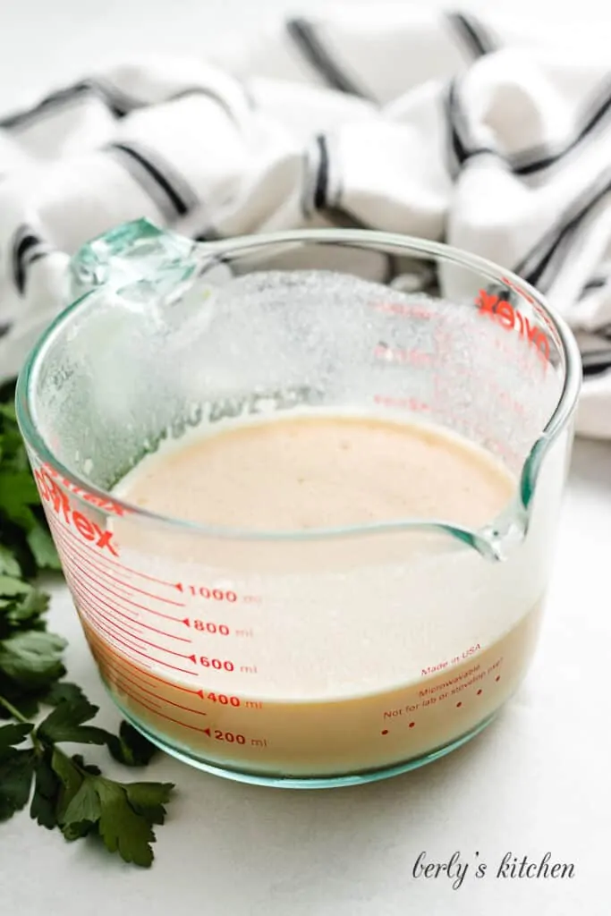 Eggs and other ingredients combined in a measuring cup.