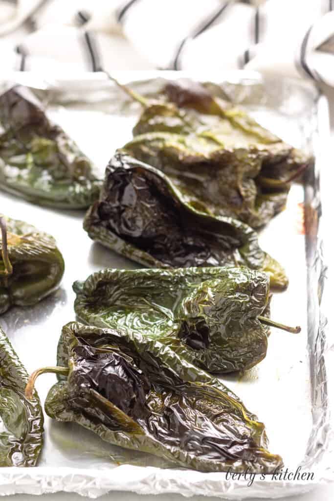 The peppers have been roasted on the sheet pan.
