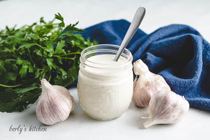 Creamy garlic dressing served with a spoon.