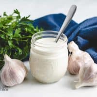 The creamy garlic dressing in a mason jar.