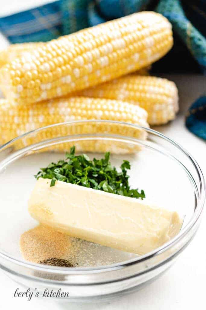 Unsalted butter and spices in a glass mixing bowl.