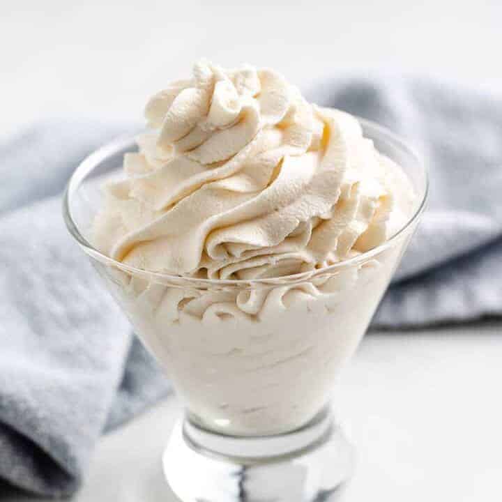 Whipped topping in a stemless wine glass.