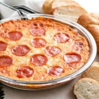 The baked pizza dip served in a pie pan.