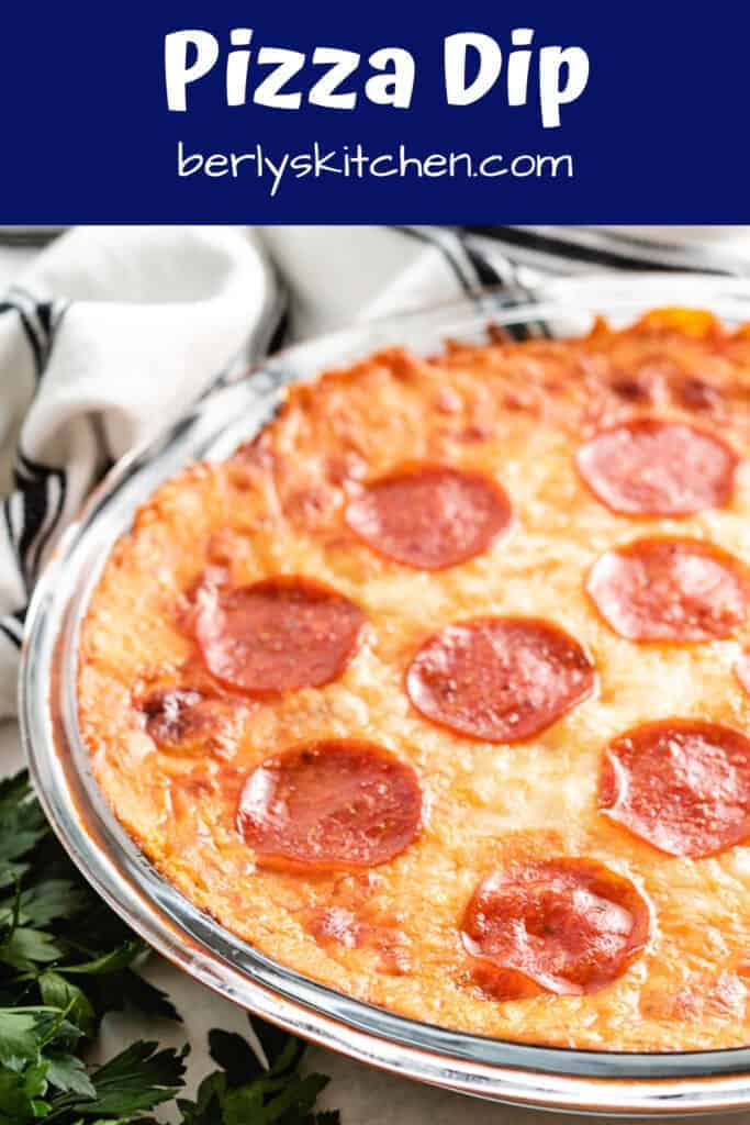 Baked pepperoni pizza dip topped with spicy pepperonis.