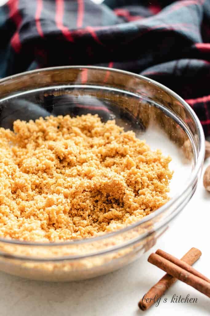 Crushed graham crackers and melted butter in a bowl.