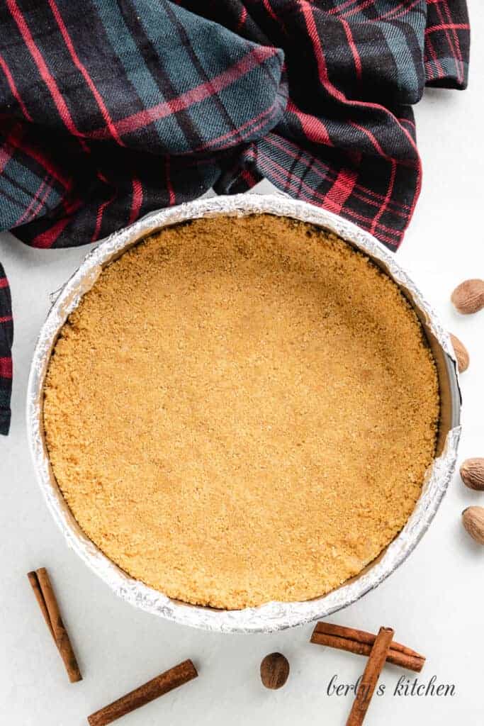The graham cracker crust in a spring-form pan.
