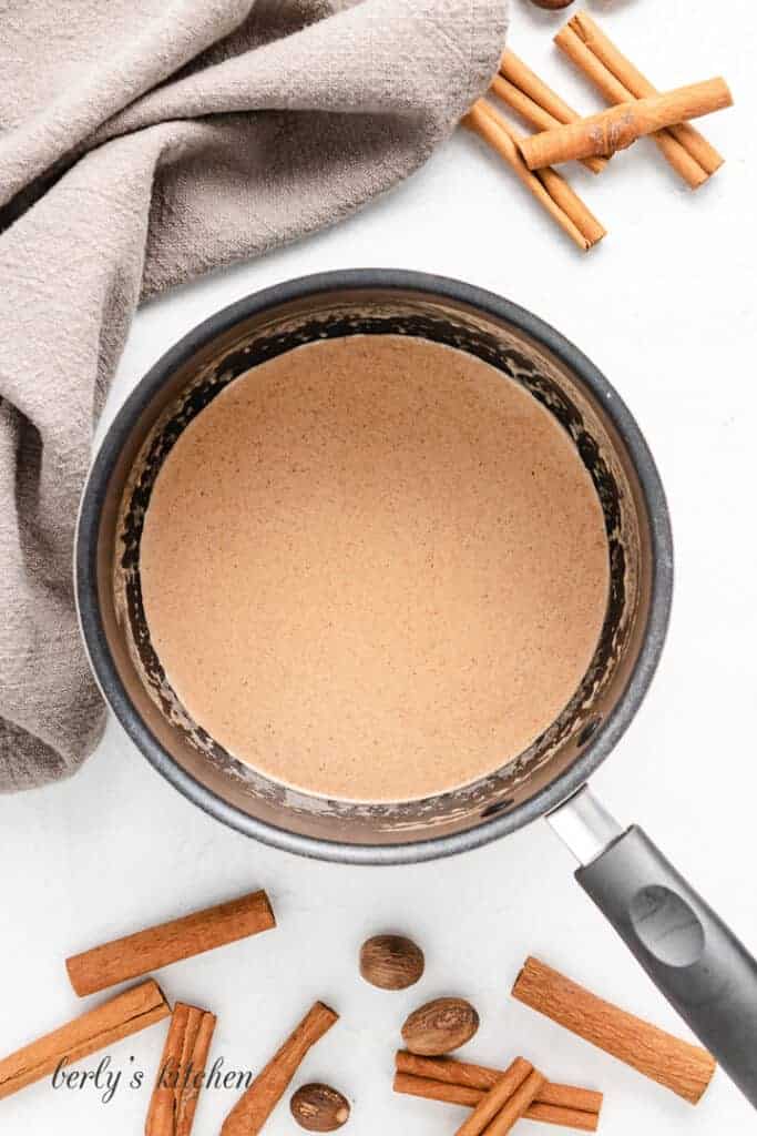 The coffee creamer heating in a pan.