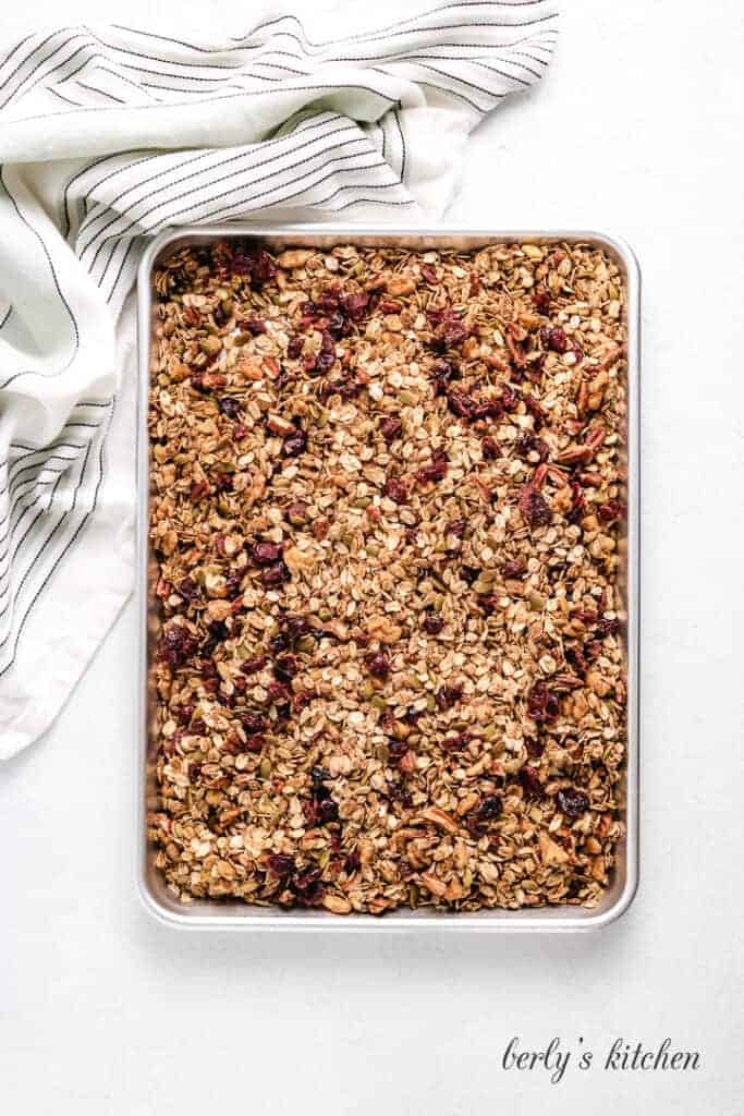 Pumpkin Spice Granola Toasted granola cooling on a sheet pan.