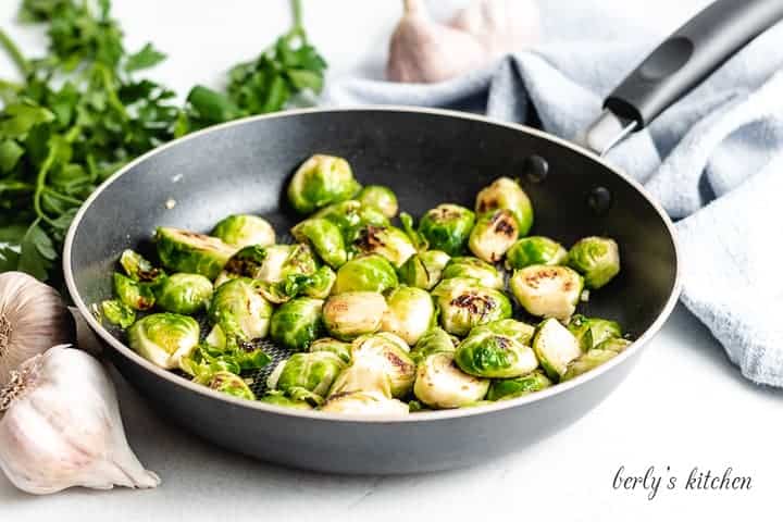 The sauteed brussel sprouts in the saute pan.