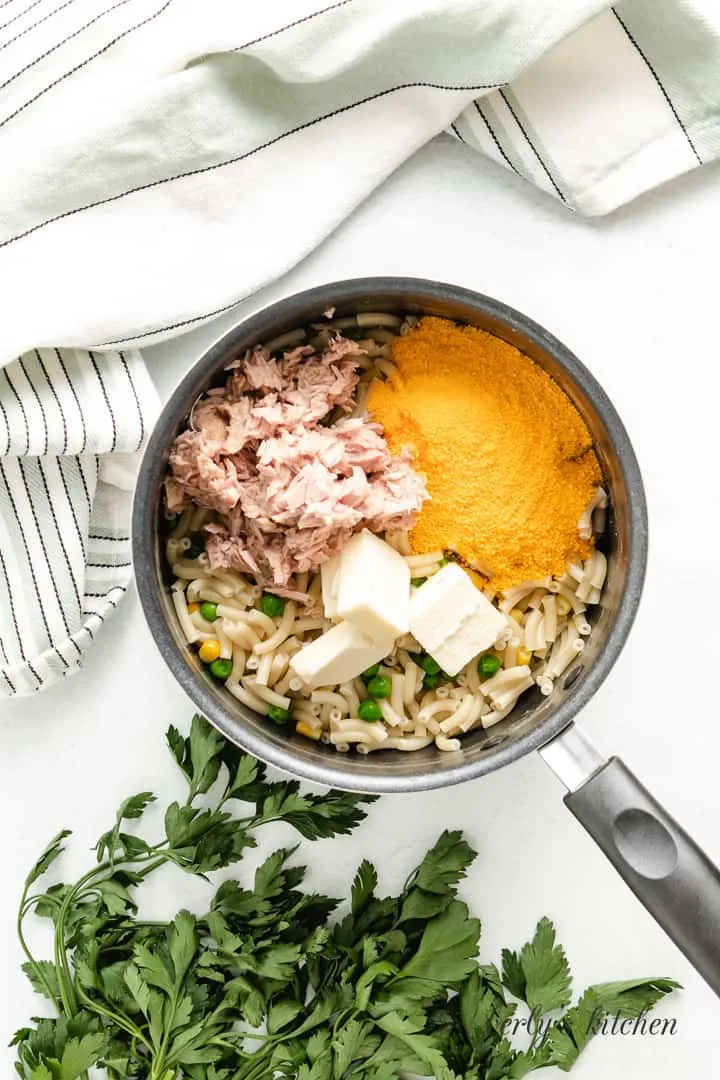 Drained pasta and vegetables returned to the pot with canned tuna added.