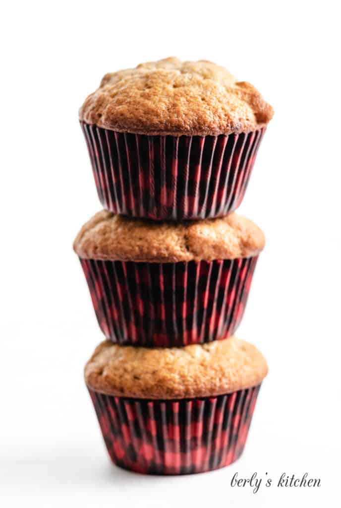Three stacked muffins on a counter.