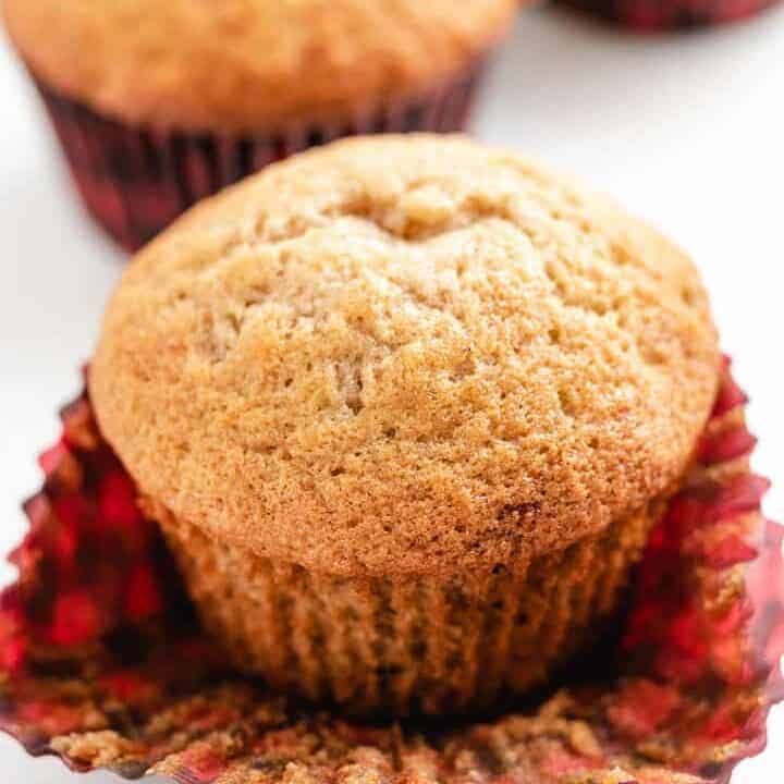 A muffin with it's liner pulled away.