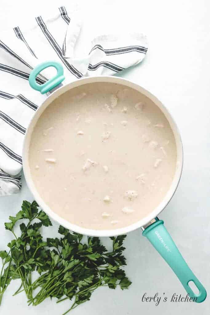 Canned soup and broth added to the pan.